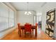Bright dining room featuring hardwood floors, a modern chandelier, and a stylish, wood dining table with seating for four at 1705 Townsend Ln, Rock Hill, SC 29730