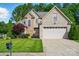 Charming brick home with lush green lawn, two-car garage, and mature trees offering curb appeal and Gathering comfort at 1705 Townsend Ln, Rock Hill, SC 29730