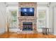 Elegant stone fireplace adding warmth to the living space, flanked by windows at 1705 Townsend Ln, Rock Hill, SC 29730