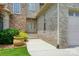 Close-up of the stone and brick front facade with a lush green lawn and landscaped garden at 1705 Townsend Ln, Rock Hill, SC 29730