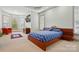 Spacious main bedroom with a bay window, tray ceiling, and a platform bed with stylish blue bedding and accent pillows at 1705 Townsend Ln, Rock Hill, SC 29730