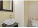 Elegant powder room with an oval glass vessel sink, modern faucet, and a decorative mirror at 1705 Townsend Ln, Rock Hill, SC 29730