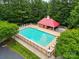 Aerial view of community pool surrounded by lounge chairs and lush trees at 1705 Townsend Ln, Rock Hill, SC 29730