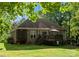 Large, wooded backyard featuring a deck, screened-in porch, and patio area at 171 Secretariat Dr, Mooresville, NC 28117