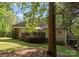 Expansive backyard with a spacious deck, screened-in porch, mature trees, and lush green lawn at 171 Secretariat Dr, Mooresville, NC 28117