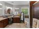 Well-lit primary bathroom featuring a soaking tub, walk-in shower, dual vanities, and tile floors at 171 Secretariat Dr, Mooresville, NC 28117