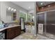 Primary bathroom boasting a soaking tub, walk-in shower, and dual vanities with granite countertop at 171 Secretariat Dr, Mooresville, NC 28117