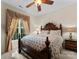Comfortable bedroom features a decorative window treatment, ceiling fan, and a classic-style bed at 171 Secretariat Dr, Mooresville, NC 28117