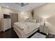 This cozy bedroom is furnished with a queen bed, ceiling fan and a nightstand with a decorative lamp at 171 Secretariat Dr, Mooresville, NC 28117