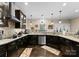 Bright kitchen featuring granite countertops, dark cabinetry, stainless steel appliances, and pendant lighting at 171 Secretariat Dr, Mooresville, NC 28117