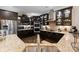 This kitchen features granite counters, tiled backsplash, stainless appliances, and ample storage with stylish dark cabinets at 171 Secretariat Dr, Mooresville, NC 28117
