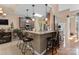 Charming kitchen with granite countertops, breakfast bar, stainless appliances, and tile backsplash at 171 Secretariat Dr, Mooresville, NC 28117