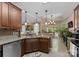 Spacious kitchen with granite countertops, bar seating, stainless steel appliances, and tile floors at 171 Secretariat Dr, Mooresville, NC 28117