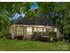 Expansive rear exterior showcasing a charming deck, screened-in porch, and well-manicured lawn at 171 Secretariat Dr, Mooresville, NC 28117