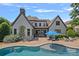 Beautiful backyard featuring a pool, patio, and elegant home exterior at 18718 Peninsula Cove Ln, Cornelius, NC 28031