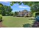 Lush green backyard featuring expansive lawn and beautifully landscaped gardens at 18718 Peninsula Cove Ln, Cornelius, NC 28031
