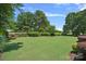 Beautifully maintained backyard featuring a spacious lawn and meticulously manicured hedges at 18718 Peninsula Cove Ln, Cornelius, NC 28031