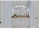 The bathroom has a marble countertop and white cabinets at 18718 Peninsula Cove Ln, Cornelius, NC 28031