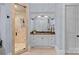 This bathroom features dual vanities, a large mirror, and a glass-enclosed shower at 18718 Peninsula Cove Ln, Cornelius, NC 28031