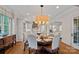 Elegant dining room with hardwood floors and an open floor plan seamlessly connects to the kitchen at 18718 Peninsula Cove Ln, Cornelius, NC 28031