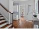 The entryway has a dark wood staircase with a display table and a glass door at 18718 Peninsula Cove Ln, Cornelius, NC 28031