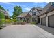 Stately Tudor-style home boasting a spacious driveway and well-manicured landscaping with a basketball hoop at 18718 Peninsula Cove Ln, Cornelius, NC 28031