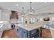 Open kitchen with stainless steel appliances, island with seating, and seamless flow to the living area, ideal for entertaining at 18718 Peninsula Cove Ln, Cornelius, NC 28031