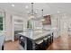 Modern kitchen with a spacious island, bar stool seating, and stainless steel appliances, perfect for culinary enthusiasts at 18718 Peninsula Cove Ln, Cornelius, NC 28031