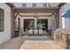 Inviting outdoor patio features a dining area, ceiling fan, and stone-clad grill, perfect for entertaining guests at 18718 Peninsula Cove Ln, Cornelius, NC 28031