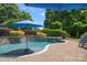 Inviting pool and patio area with lush landscaping and a relaxing atmosphere at 18718 Peninsula Cove Ln, Cornelius, NC 28031