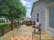 Inviting wooden back deck, complete with seating, overlooks a beautiful yard and charming detached living space at 2223 Jon Chris Dr, Harrisburg, NC 28075