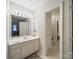 Bright bathroom with modern lighting, vanity, large mirror, and tiled floors at 2223 Jon Chris Dr, Harrisburg, NC 28075