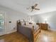 Cozy bedroom featuring wood floors, ceiling fan, and a door to the outside patio at 2223 Jon Chris Dr, Harrisburg, NC 28075