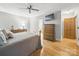 Bedroom showcasing wood floors, dresser and mounted television at 2223 Jon Chris Dr, Harrisburg, NC 28075