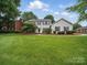Charming two-story home with manicured lawn, tasteful landscaping and classic architectural details at 2223 Jon Chris Dr, Harrisburg, NC 28075