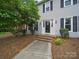 Traditional home featuring a classic front door and manicured landscaping at 2223 Jon Chris Dr, Harrisburg, NC 28075