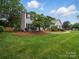 Two story home with well-manicured lawn and mature landscaping at 2223 Jon Chris Dr, Harrisburg, NC 28075