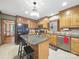 Kitchen with wooden cabinets, tile backsplash, granite countertops, black appliances, and island with seating at 2223 Jon Chris Dr, Harrisburg, NC 28075