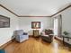 Cozy living room with beautiful hardwood floors, natural lighting, and classic decor with a neutral color palette at 2223 Jon Chris Dr, Harrisburg, NC 28075