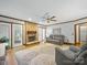 Inviting living room with a cozy brick fireplace, neutral color palette, and hardwood floors throughout the space at 2223 Jon Chris Dr, Harrisburg, NC 28075