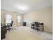 Spacious office with neutral carpet, multiple desks, ergonomic chairs, and natural light from large windows at 2223 Jon Chris Dr, Harrisburg, NC 28075