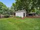 Charming outbuilding with siding and garden, nestled in a lush green lawn at 2223 Jon Chris Dr, Harrisburg, NC 28075