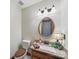 Well-lit powder room showcases granite countertop, wood vanity, decorative mirror and lighting fixtures at 2223 Jon Chris Dr, Harrisburg, NC 28075