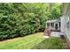 Backyard features a secluded screened porch with stairs, perfect for relaxing in a natural setting at 2504 Korbel Ct, Waxhaw, NC 28173