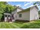 The backyard features lush green grass, trees, a back deck and screened-in porch perfect for outdoor enjoyment at 2504 Korbel Ct, Waxhaw, NC 28173