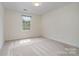 Empty bedroom with neutral carpet and a large window for natural light at 2504 Korbel Ct, Waxhaw, NC 28173
