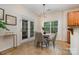 Cozy breakfast nook featuring a round table, four chairs, a modern light fixture, and natural light from the window at 2504 Korbel Ct, Waxhaw, NC 28173