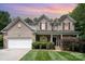 Stately brick home with manicured lawn, lush landscaping, and inviting curb appeal at 2504 Korbel Ct, Waxhaw, NC 28173