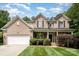 Charming brick home featuring a well-manicured lawn, attached two-car garage, and inviting front porch at 2504 Korbel Ct, Waxhaw, NC 28173
