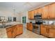 Functional kitchen featuring wooden cabinets, stainless steel oven, and granite countertops for meal preparation at 2504 Korbel Ct, Waxhaw, NC 28173